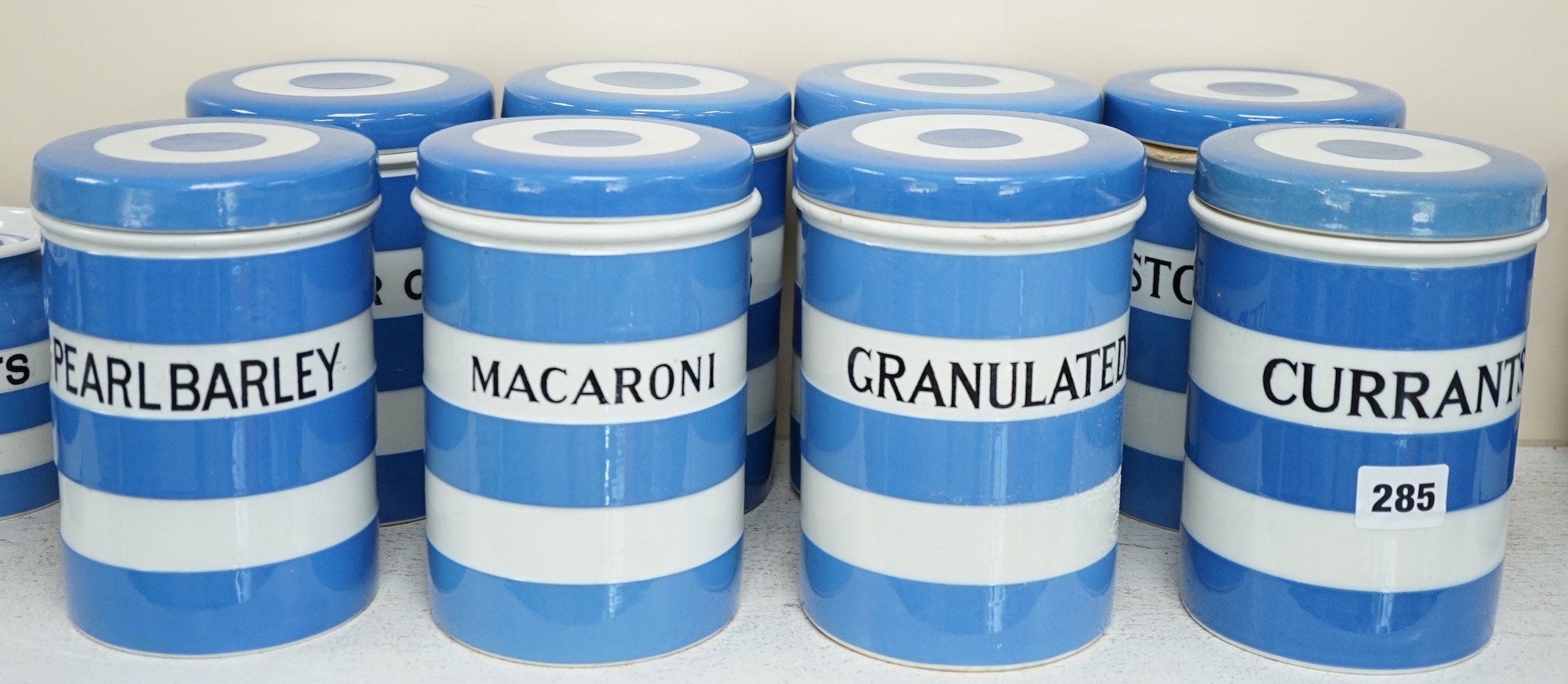 T.G.Green Cornish Kitchenware, eight 17cm lidded storage jars, comprising Currants, Caster Sugar, Granulated Sugar, Indian Tea, Macaroni, Biscuits, Pearl Barley and Quaker, Oats, Black Shield marks. Condition - fair to g